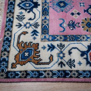 Pink ivory Kazak rug corner detail with ivory border