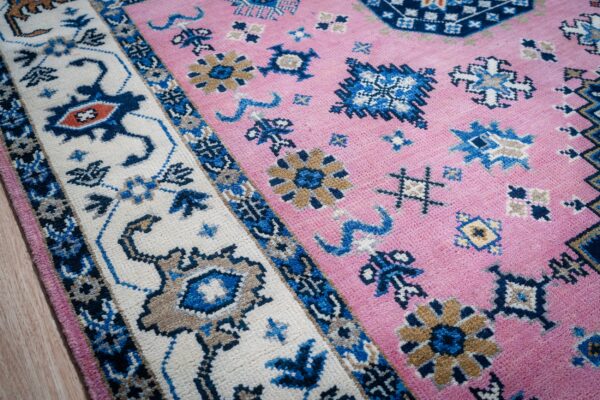 Pink ivory kazak rug corner and border detail