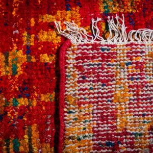 Sari-silk red abstract Anand rug hand-knotted back and fringe detail