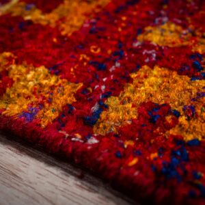 Sari-silk red abstract Anand rug edge and pile texture close-up