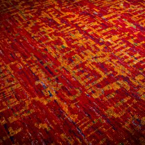 Sari-silk red abstract Anand rug angled field detail