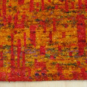 Close-up of Anand rug recycled sari-silk pile texture in red and gold