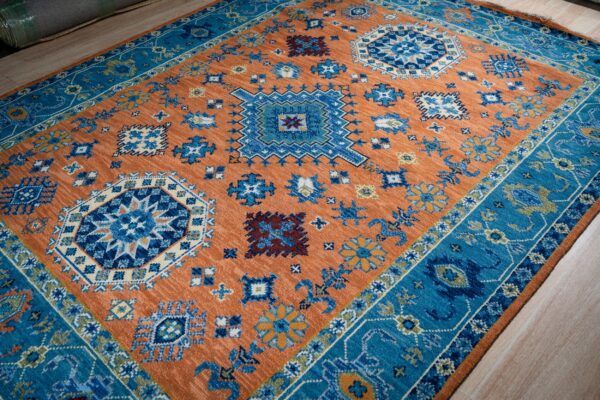 Rust blue kazak hand-knotted rug, angled full view