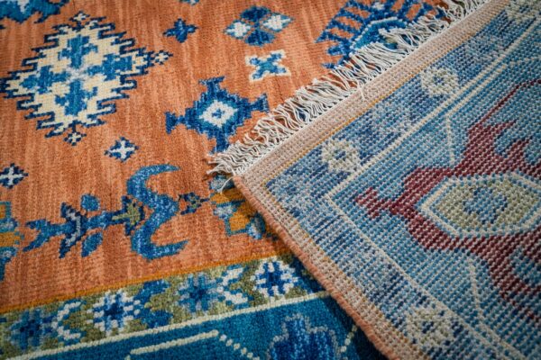 Rust blue kazak rug hand-knotted back and fringe detail