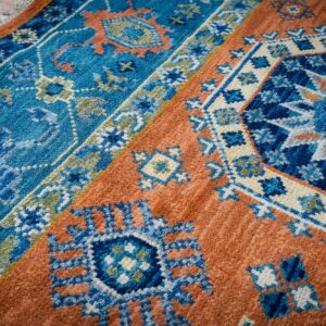 Rust blue Kazak rug field and border detail