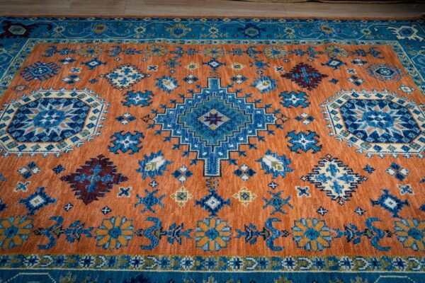 Rust blue kazak rug field and medallion detail