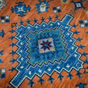 Rust blue Kazak rug central medallion close-up