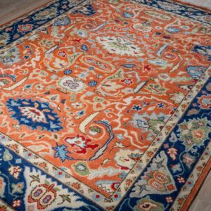 Rust Oushak floral wool rug, angled full view