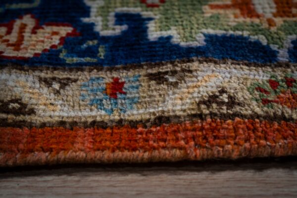 Rust oushak rug edge and pile detail