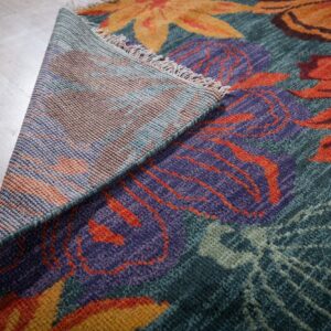 Teal contemporary floral rug back corner detail