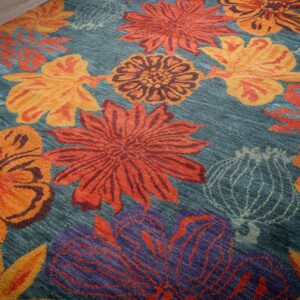 Teal contemporary floral rug angled field detail with bold blossoms