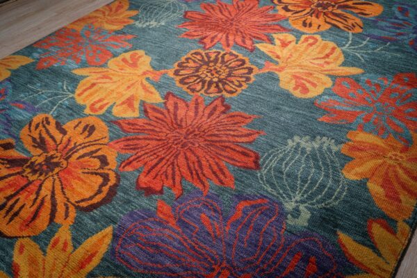 Teal contemporary floral rug angled field detail with bold blossoms