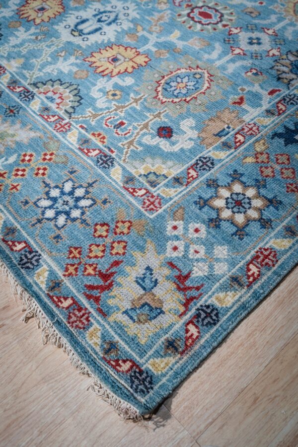 Turquoise oushak rug corner and border detail