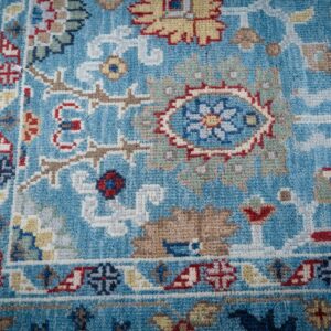 Turquoise Oushak rug corner and floral border detail
