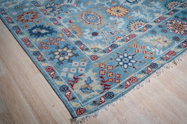 Turquoise oushak rug corner and fringe detail