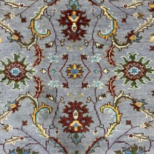 Dahlia Oriental Gray Hand Knotted Wool Rug, a gray wool rug with a traditional oriental pattern in a brightly lit living room