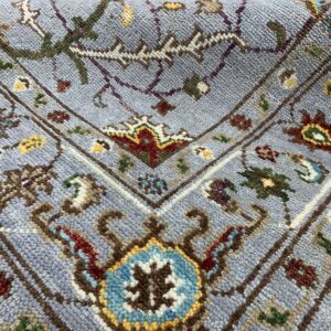 Dahlia Oriental Gray Hand Knotted Wool Rug softly illuminating a modern living room with intricate hand-knotted patterns in subtle grays