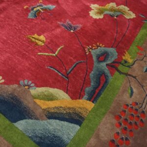Border detail of a red Chinese Art Deco rug showing blue, teal and olive rockwork mounds and a red berry cluster