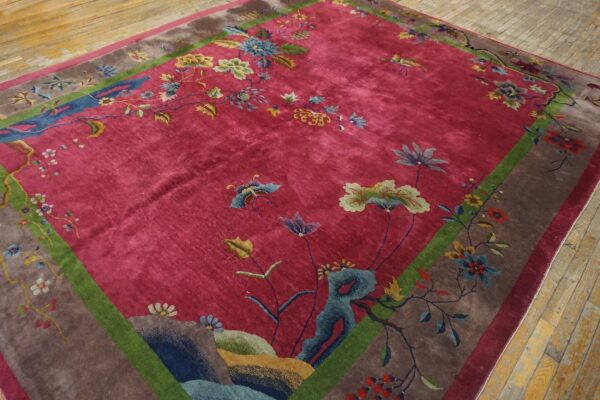 Antique red color classic chinese art deco design room size carpet 12 Angled corner of a red 1920s chinese art deco rug on wood flooring, with blue rockwork and teal and cream florals