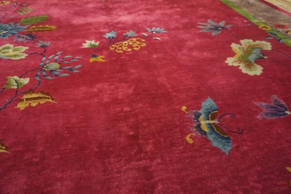 Antique red color classic chinese art deco design room size carpet 7 Field detail of a red chinese art deco rug with a blue butterfly, cream and olive blossoms and a gold chrysanthemum