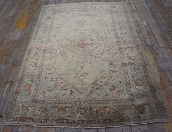 Elegant intricate ivory background color in a medallion pattern antique persian tabriz rug - detail view 1