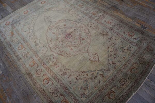 Elegant intricate ivory background color in a medallion pattern antique persian tabriz rug - detail view 3