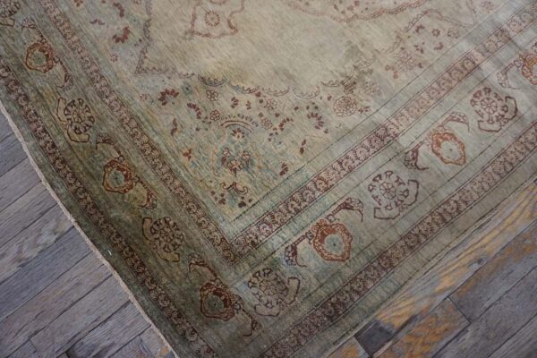 Elegant intricate ivory background color in a medallion pattern antique persian tabriz rug - detail view 5