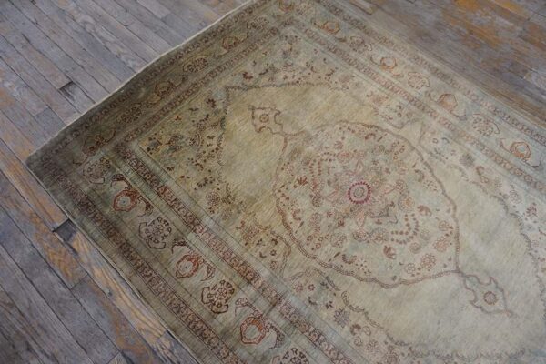 Elegant intricate ivory background color in a medallion pattern antique persian tabriz rug - detail view 7