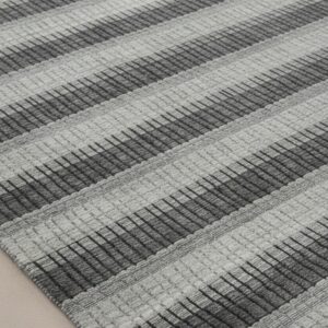 Gray contemporary geometric loom-check wool and viscose area rug styled in a living room