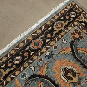 Gray and navy traditional hand-knotted wool rug KR110GY shown in a styled interior setting
