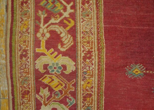 Spellbinding red-raspebery fiedl with delicate medallion pattern antique turkish ghiordes oushak rug 5 Spellbinding red-raspebery fiedl with delicate medallion pattern antique turkish ghiordes oushak rug - detail view 4