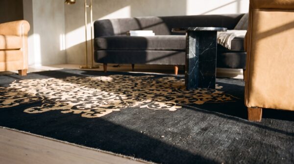 1920s hand knotted pile antique rectangle wool black floral medallion rug (sku 25492) - in-room detail