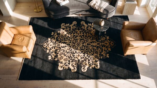 1920s hand knotted pile antique rectangle wool black floral medallion rug (sku 25492) - styled overhead view