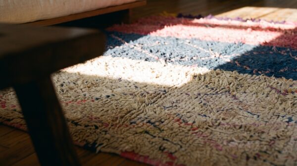 Allover geometric hand knotted pile wool 1940s multicolor jewel tones boucherouitte antique rug (sku 22447) - in-room detail
