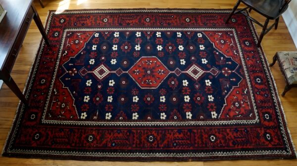 Antique allover tribal floral pattern persian baluch rug (sku 24282) - styled overhead view