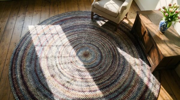 Antique american braided colorful round area rug (sku 25393) - styled overhead view