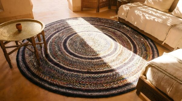 Antique american braided round geometric area rug (sku 25666) - styled overhead view