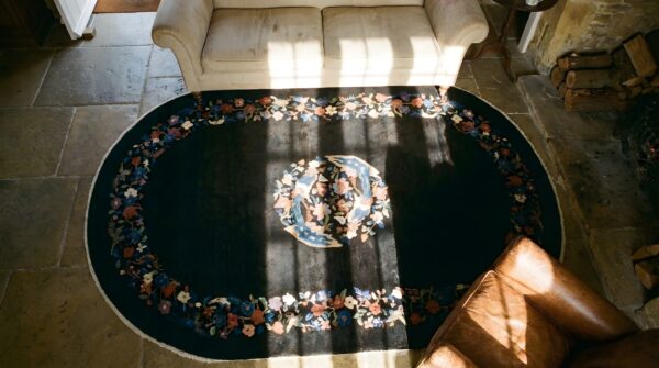 Antique art deco small oval wool black rug 2 Antique art deco small oval wool black rug (sku 24465) - styled overhead view