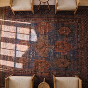 Blue Bold Tribal Design Antique Wool Pile Persian Baluch Rug (SKU 24181) - styled overhead view