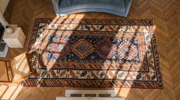 Hand knotted wool pile antique blue color allover tribal geometric caucasian rug 2 Hand knotted wool pile antique blue color allover tribal geometric caucasian rug (sku 19577) - styled overhead view
