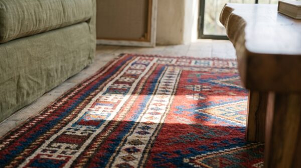 Bold bright red antique late 19th century tribal geometric caucasian kazak rug 9 Bold bright red antique late 19th century tribal geometric caucasian kazak rug (sku 19293) - in-room detail