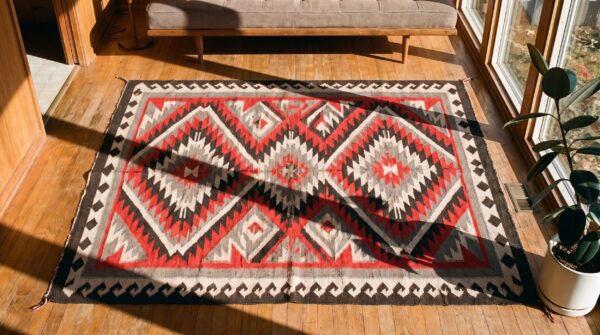 Bold graphic geometric tribal pattern antique native american navajo flat weave red rug (sku 21272) - styled overhead view