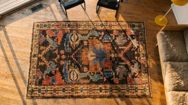 Brown rustic large scale tribal design antique persian bakhtiari rug 2 Brown rustic large scale tribal design antique persian bakhtiari rug (sku 18136) - styled overhead view