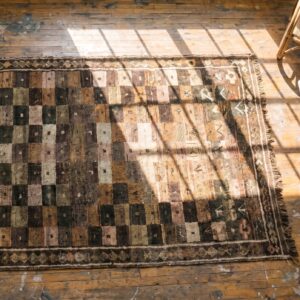 Brown Antique Tribal Geometric Checkerboard Pattern Wool Persian Gabbeh Rug (SKU 18929) - styled overhead view