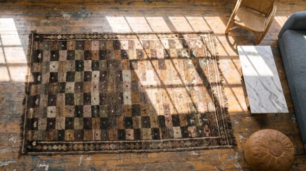 Brown antique tribal geometric checkerboard pattern wool persian gabbeh rug 2 Brown antique tribal geometric checkerboard pattern wool persian gabbeh rug (sku 18929) - styled overhead view