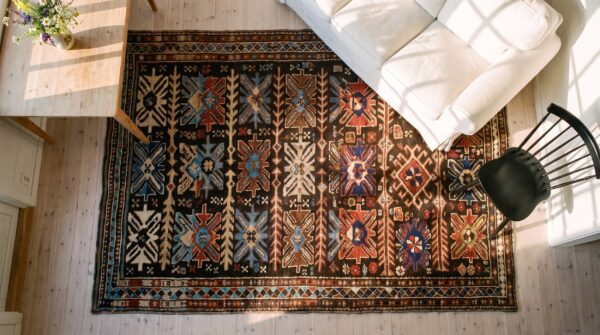 Antique caucasian karabagh rug 3'4"×6'3" brown tribal, ivory border, circa 1900 (sku 18014) - styled overhead view