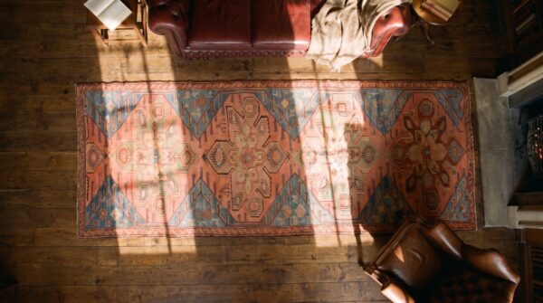 Antique caucasian karabagh hallway runner wool coral rug 2 Antique caucasian karabagh hallway runner wool coral rug (sku 19581) - styled overhead view