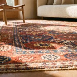 Antique Caucasian Kazak Rug 4'×8'2" Multi Geometric, Rose Pink Border, Circa 1890 (SKU 19098) - in-room detail