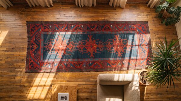 Antique caucasian kilim knotted hallway runner rug (sku 21111) - styled overhead view