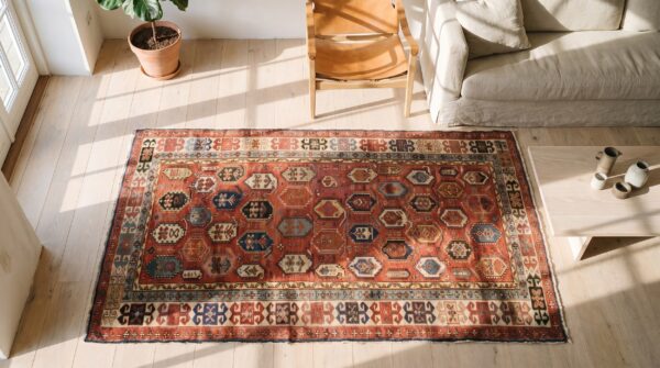 Antique caucasian shirvan hallway runner wool coral rug 2 Antique caucasian shirvan hallway runner wool coral rug (sku 19704) - styled overhead view
